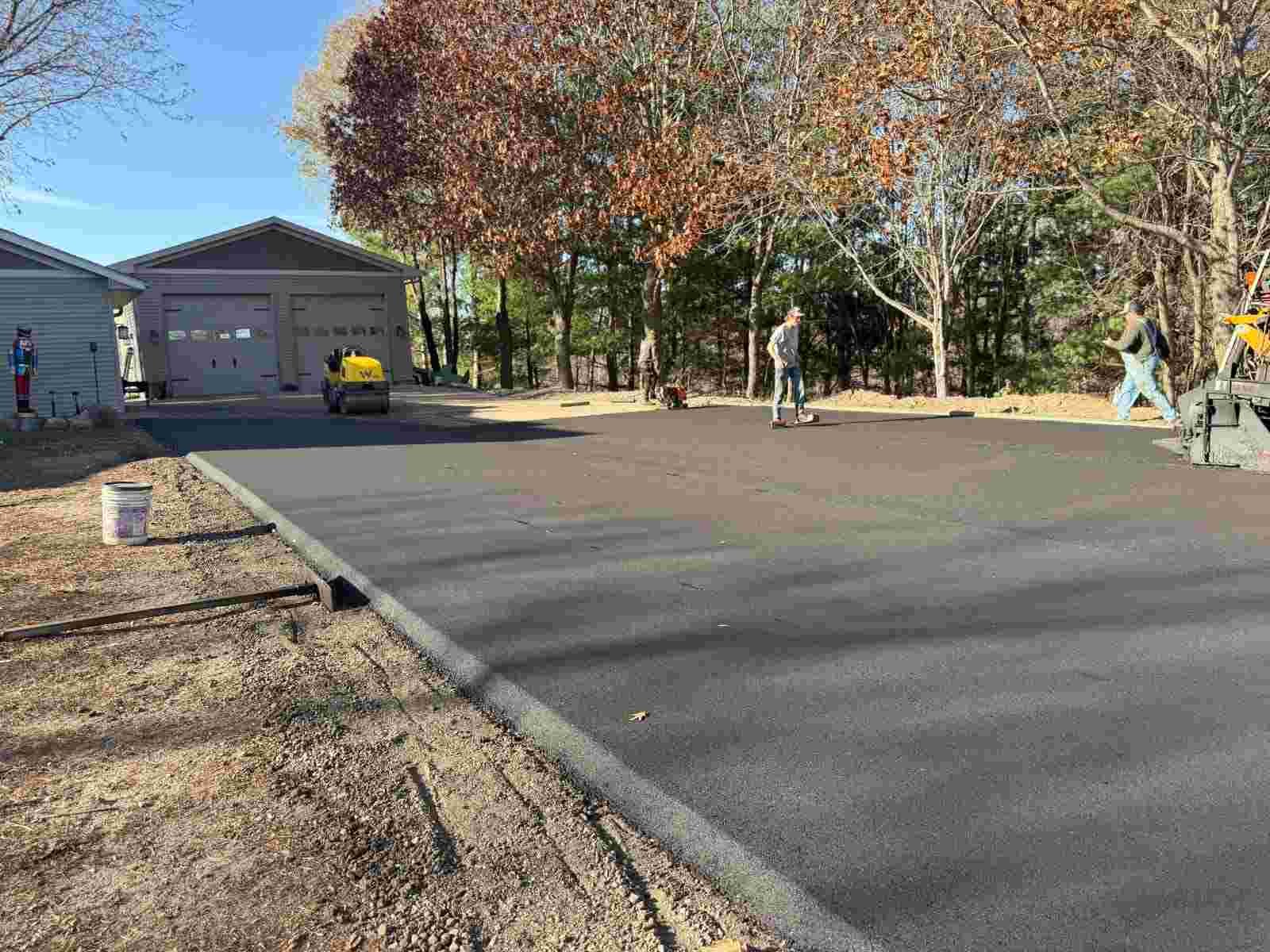 Workers of Durable Paving that's asphalting a commercial space's lot.