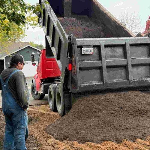 Durable Paving's truck that's unloading asphalt.